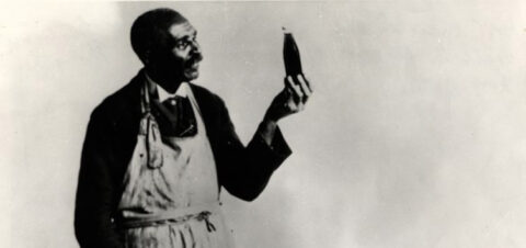 a black and white portrait of Carver holding a bottle.