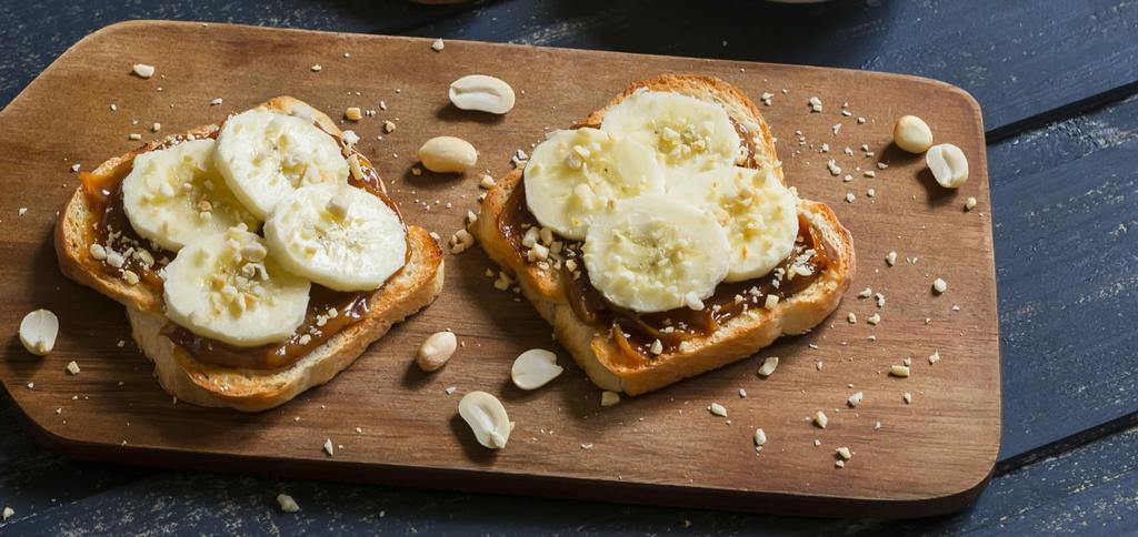 peanut butter spread on bread topped with banana slices.