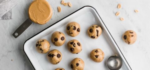 a tray of peanut cookies with chocolate chips before going to the oven.